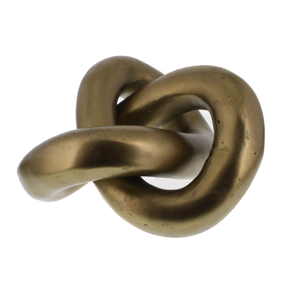 Sculptural brass knot, a continuous folded loop, on a shelf