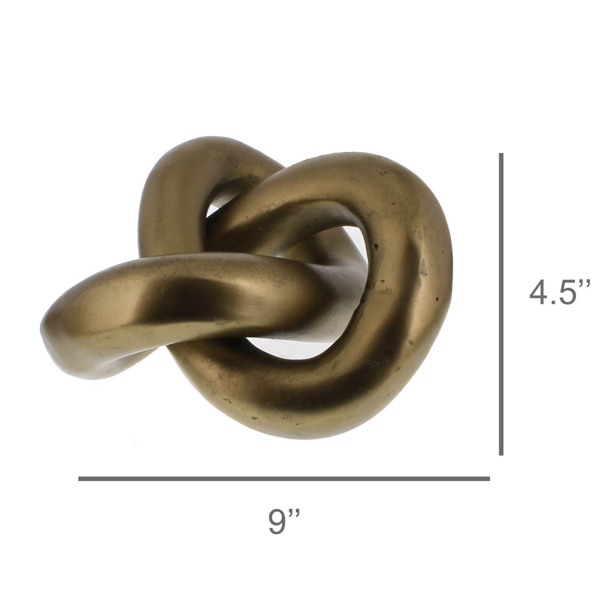 Sculptural brass knot, a continuous folded loop, on a shelf
