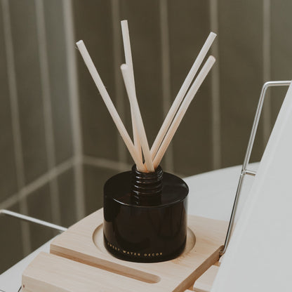 Amber jar diffuser styled in a bathroom scene