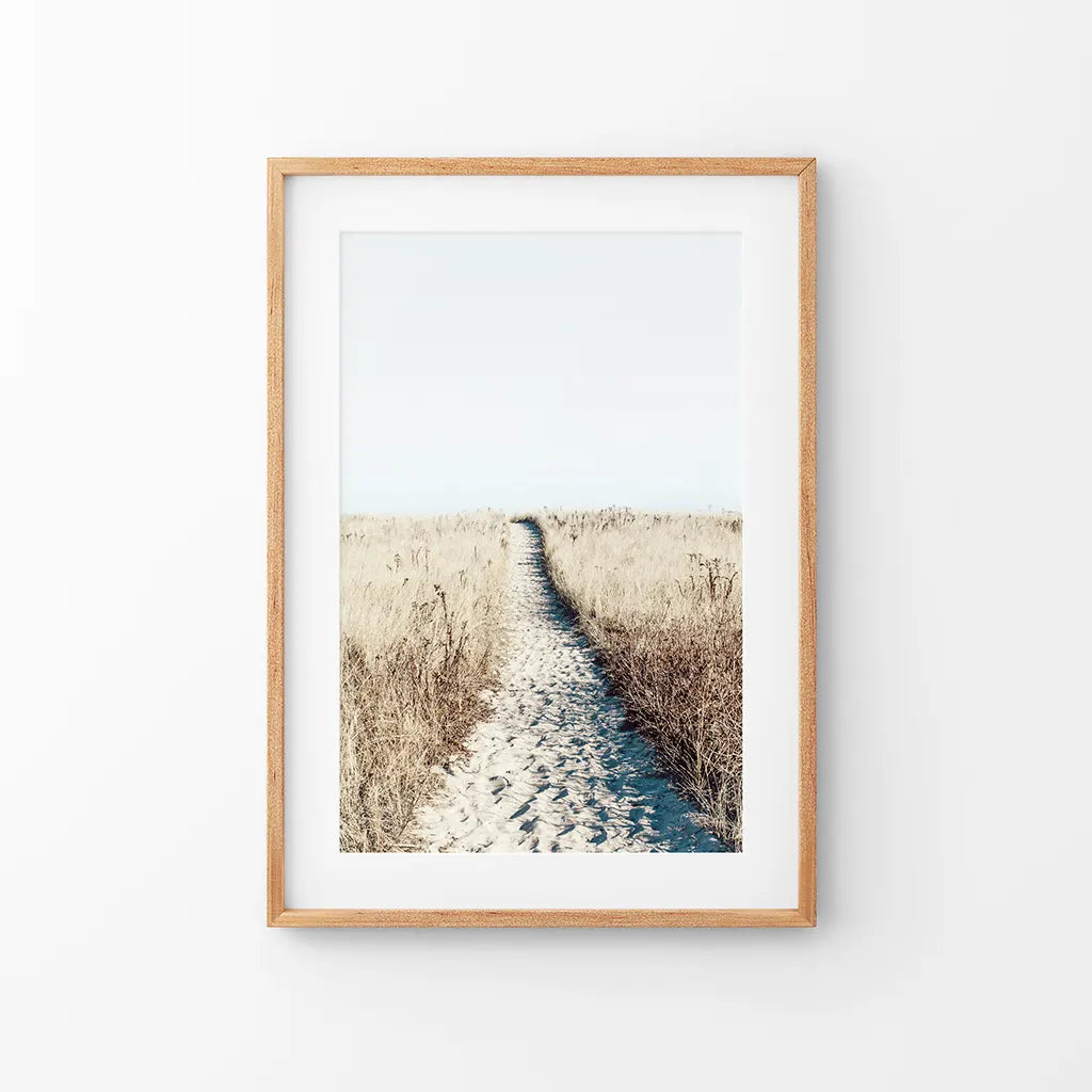 Framed print of a sand path through golden dune grass, thin wood frame with mat