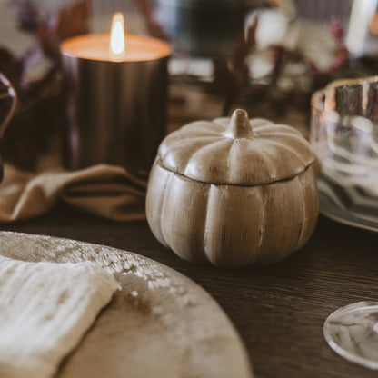 Pumpkin spice candle styled on a fall table