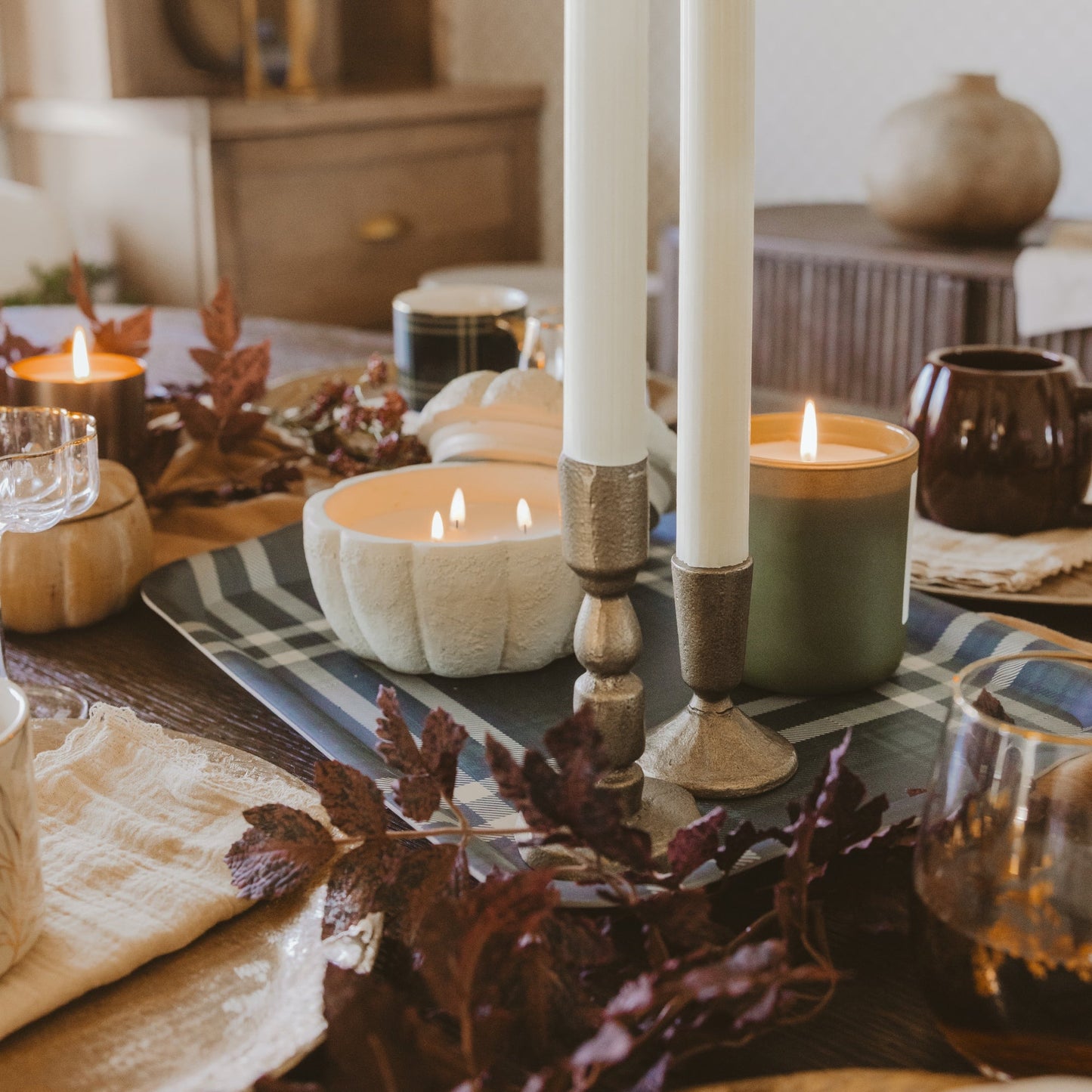 Pumpkin candle styled in a fall tablescape
