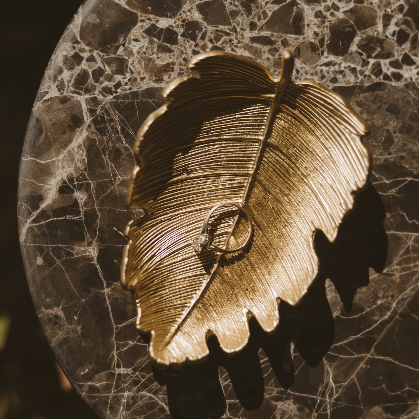 Gold leaf dish styled with jewelry