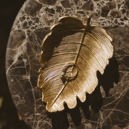 Gold leaf dish styled with jewelry