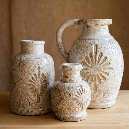 Carved floral vases in crackled white glaze in bottle, jug and bud shapes