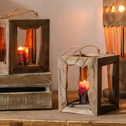 Farmhouse wood frame lanterns with rope handles holding lit candles