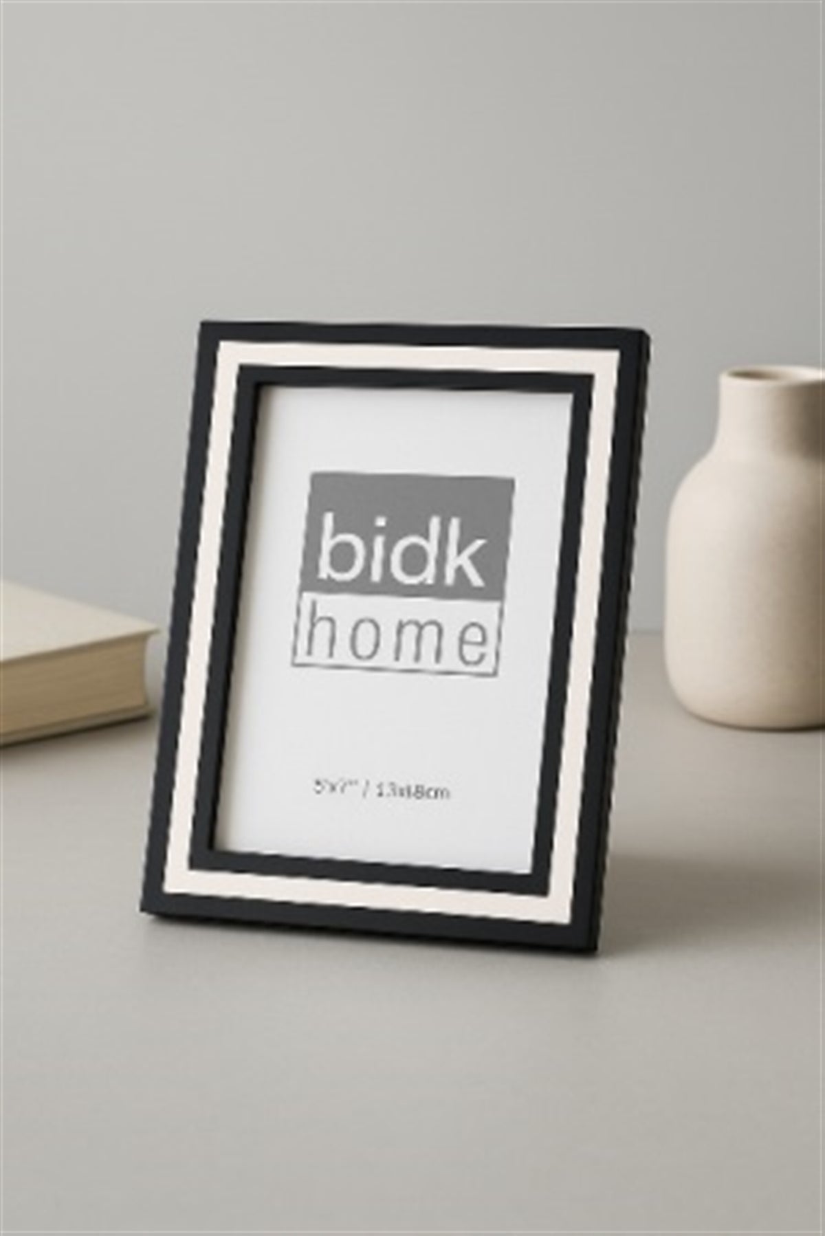 Line Frame, Black & White by BIDKhome — 5 × 7 on a table