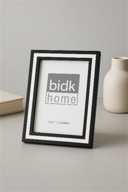 Line Frame, Black & White by BIDKhome — 5 × 7 on a table
